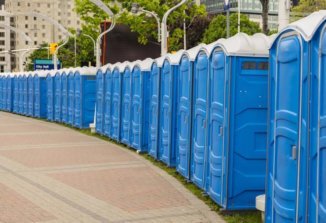 portable restrooms stationed outside of a high-profile event, with attendants available for assistance in Battleboro